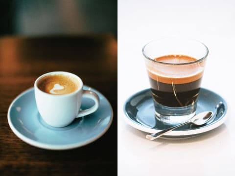 Side-by-side comparison of espresso served in a white ceramic cup with latte art and in a clear glass cup on saucers