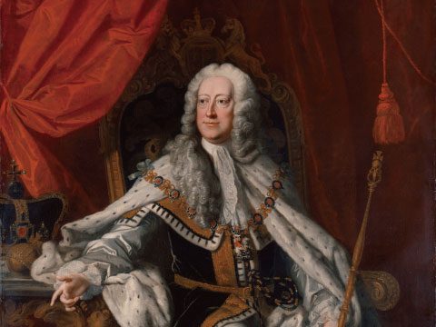 A formal portrait of King George II seated in coronation robes and ermine, holding a scepter with a crown displayed nearby