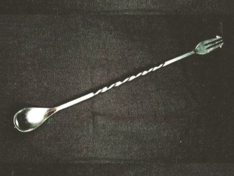 A stainless steel bar spoon with a twisted handle, a rounded bowl on one end and a small fork on the other