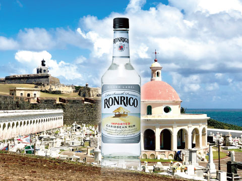 A bottle of Ronrico white rum standing in front of a historic fort and cemetery in Puerto Rico