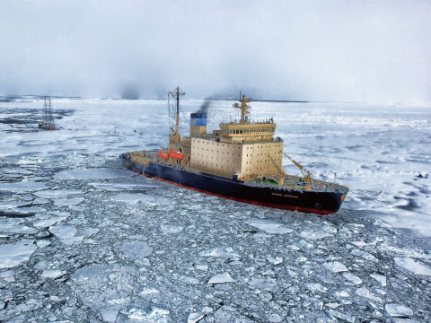 An icebreaker ship navigating through broken sea ice in an arctic landscape