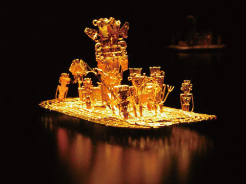 A miniature gold raft adorned with ceremonial figures, representing the ritual said to have inspired the legend of El Dorado