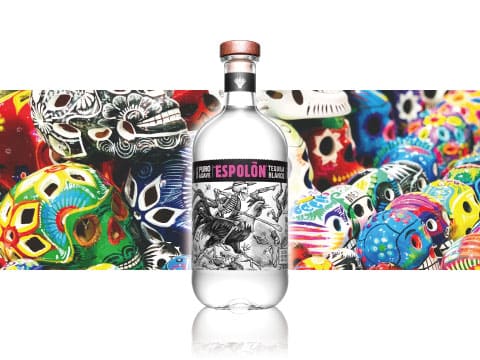 A bottle of Espolòn Blanco silver tequila displayed against colorful Mexican sugar skull artwork