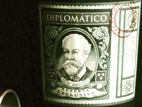 A close-up of the Diplomático rum label, showing the portrait of Don Juancho and the words Reserva Exclusiva
