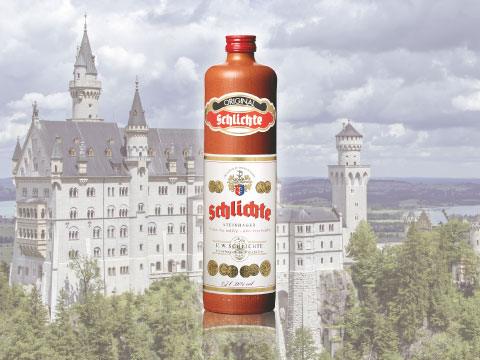 A brown earthenware bottle of Schlichte Steinhäger gin superimposed against a fairytale-style German castle