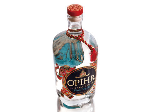 Bottle of Opihr Oriental Spiced London Dry Gin with a red cap, red tassel cord and ornate oriental-style label on a white background