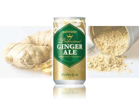 Gold and green can of Suntory Professional Ginger Ale, a smooth Japanese ginger ale, in front of fresh ginger root and ginger powder