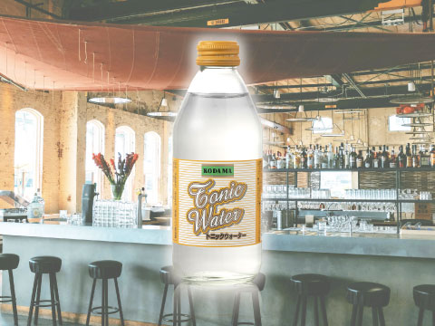 Glass bottle of Kodama Tonic Water with a retro label, a light Japanese tonic, in front of a bright bar counter