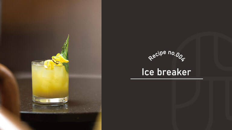 A yellow Ice Breaker cocktail in a rocks glass, garnished with a citrus twist and a tropical leaf, with "Recipe no.004, Ice Breaker" text overlay