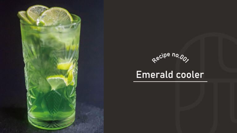 A vivid green Emerald Cooler cocktail in a cut-crystal Collins glass, garnished with lime wheels and wedges, with "Recipe no.001, Emerald Cooler" text overlay