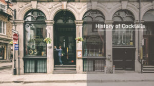 A historic storefront with arched windows and a "Santos" sign, next to text reading "History of Cocktails," representing the journey of cocktail history through time
