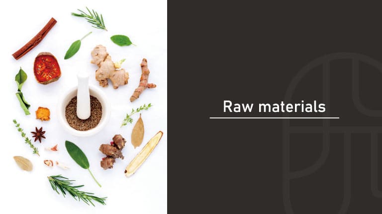 Various herbs, spices, and botanicals including cinnamon, ginger, and rosemary arranged around a mortar and pestle with ground spice inside