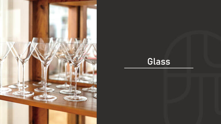 Rows of martini glasses lined up on a wooden bar shelf, with "Glass" text overlay introducing a guide to cocktail glassware