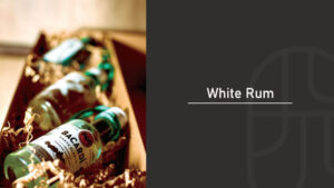 Bottles of white rum nestled in a wooden gift box with excelsior packing material