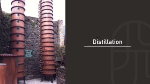 Tall copper Coffey still columns used for continuous distillation at a whisky distillery