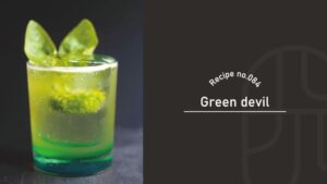 Green Devil cocktail in a rocks glass with mint leaf garnish, showing a green-to-blue gradient over dark ice