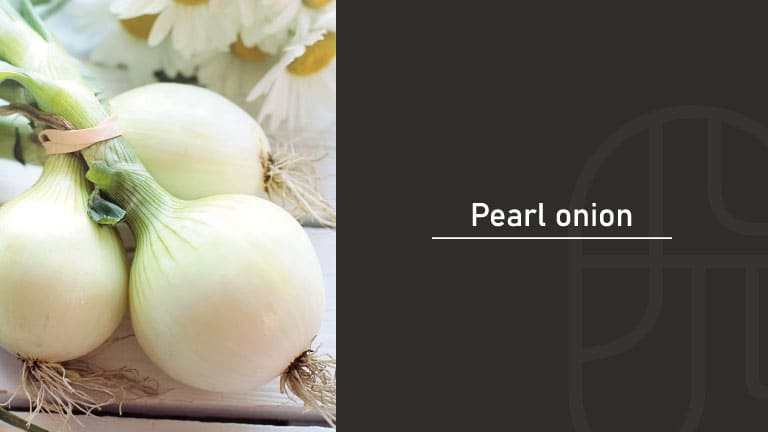 Three fresh white pearl onions with green stems tied together, resting near white daisy flowers, beside a "Pearl onion" title card
