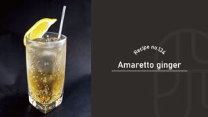 Amaretto Ginger cocktail with a sparkling golden-amber color over ice in a tall glass, garnished with a lemon wedge and a silver straw against a black background