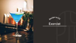 A vivid blue Exorcist cocktail with a sugared rim in a martini glass, garnished with a lime twist, on a dark wooden bar counter, beside a "Recipe no.113 Exorcist" title card