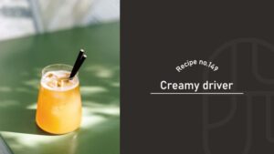 Creamy Driver cocktail, a frothy orange vodka drink with egg yolk, served on the rocks with black straws in a short glass