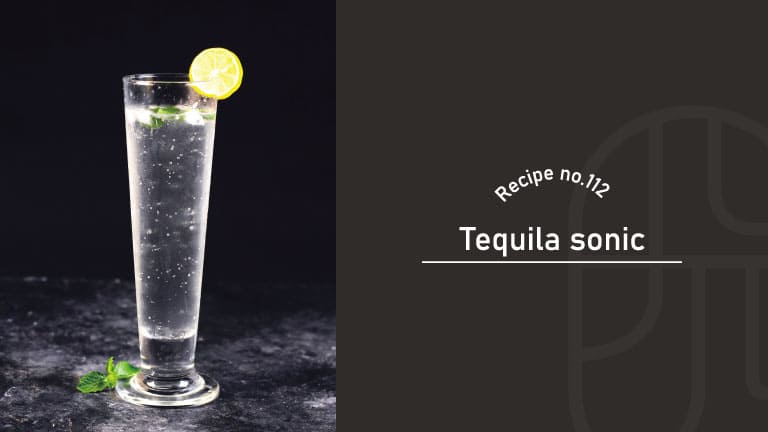 A clear Tequila Sonic in a tall pilsner glass garnished with a lemon wheel and mint, on a dark stone surface, beside a "Recipe no.112 Tequila sonic" title card