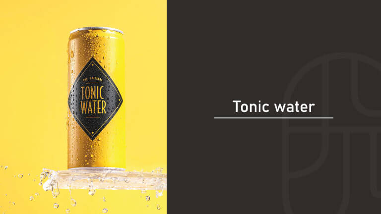 Chilled can of tonic water covered in water droplets on a splash of water against a yellow background, with the title "Tonic water"
