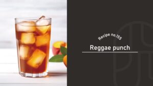 Reggae Punch cocktail, an amber peach and tea highball over ice in a tall glass, with fresh peaches and green leaves on a white wooden table, Recipe No.155